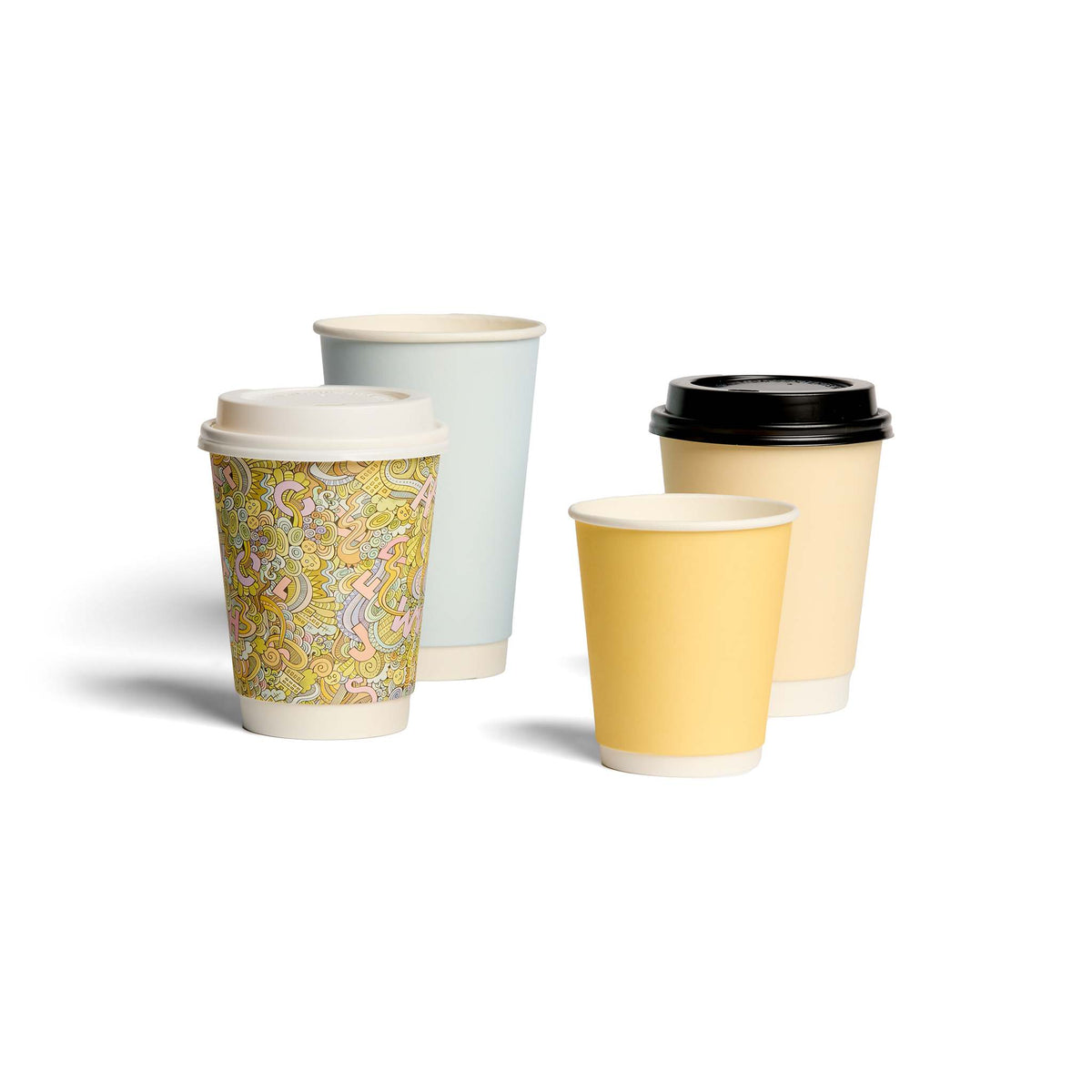 Four takeaway coffee cups in pastel colours and an illustrated design, with lids, arranged on a white background