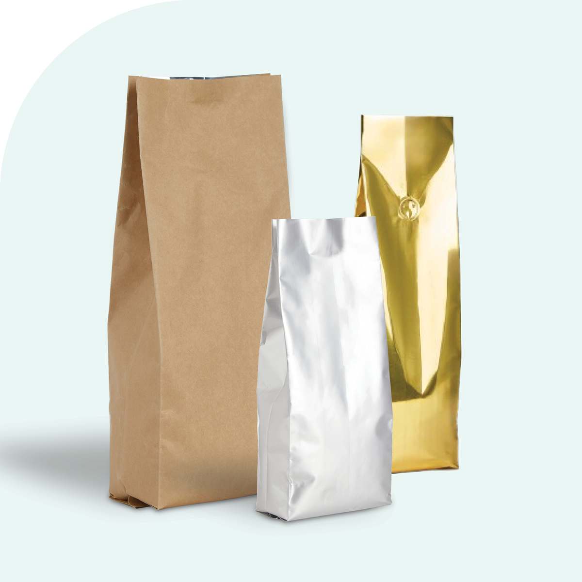Three plain side gusset pouches in kraft brown, shiny silver, and metallic gold against a light background