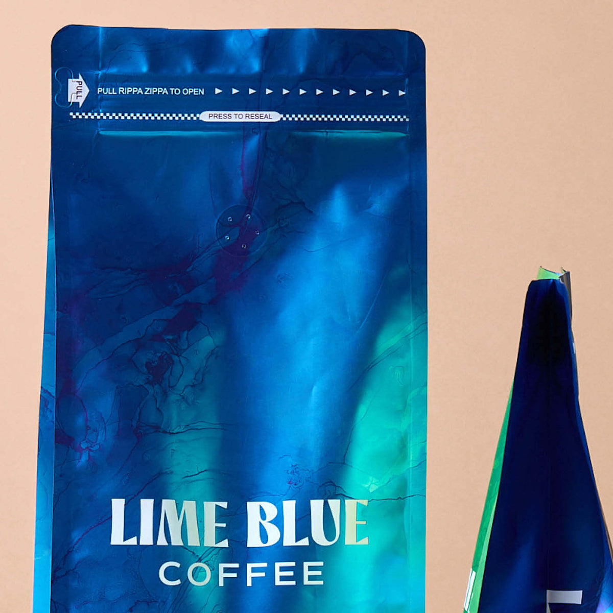 Blue and teal marble coffee pouch printed with Lime Blue Coffee, featuring a resealable zip on a beige background