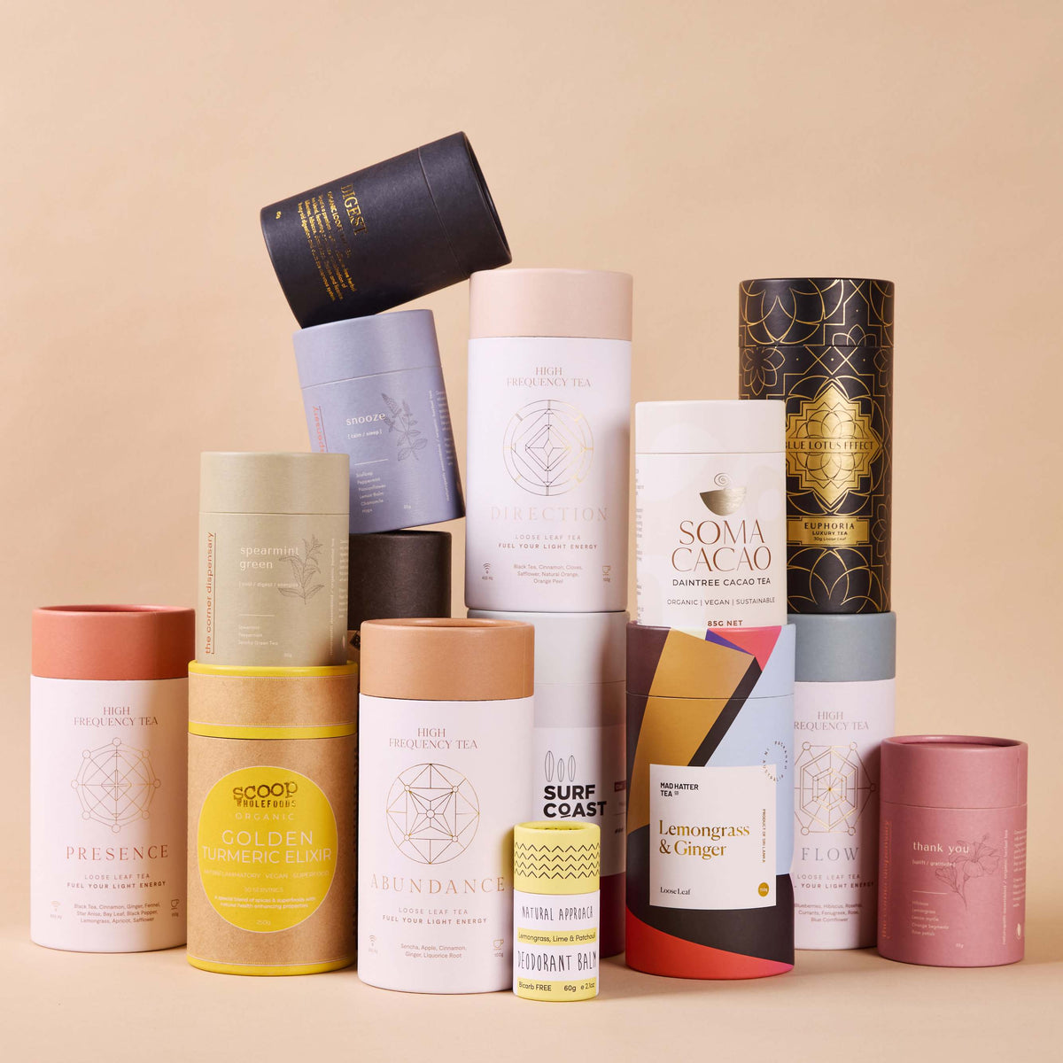 A collection of custom-printed packaging cylinders in various colours, designs and sizes on a neutral background