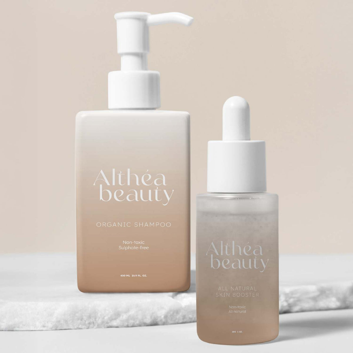 Gradient beige pump bottle and matching dropper bottle with custom white print, set on a textured white surface