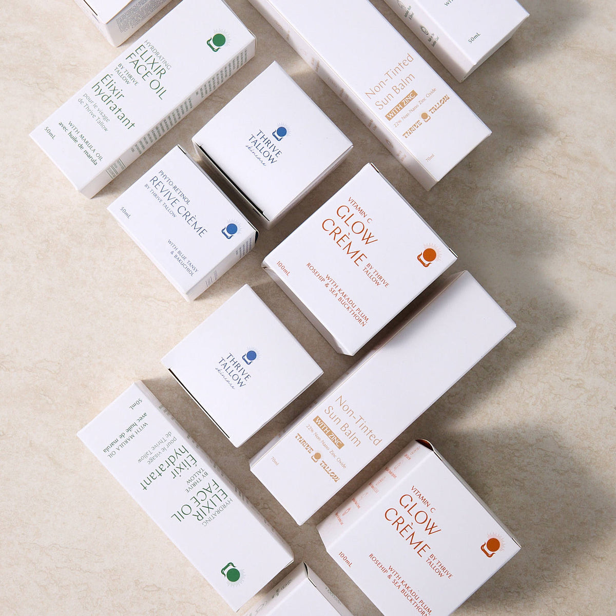 Custom-printed white skincare cartons and cosmetic boxes arranged on a light stone surface