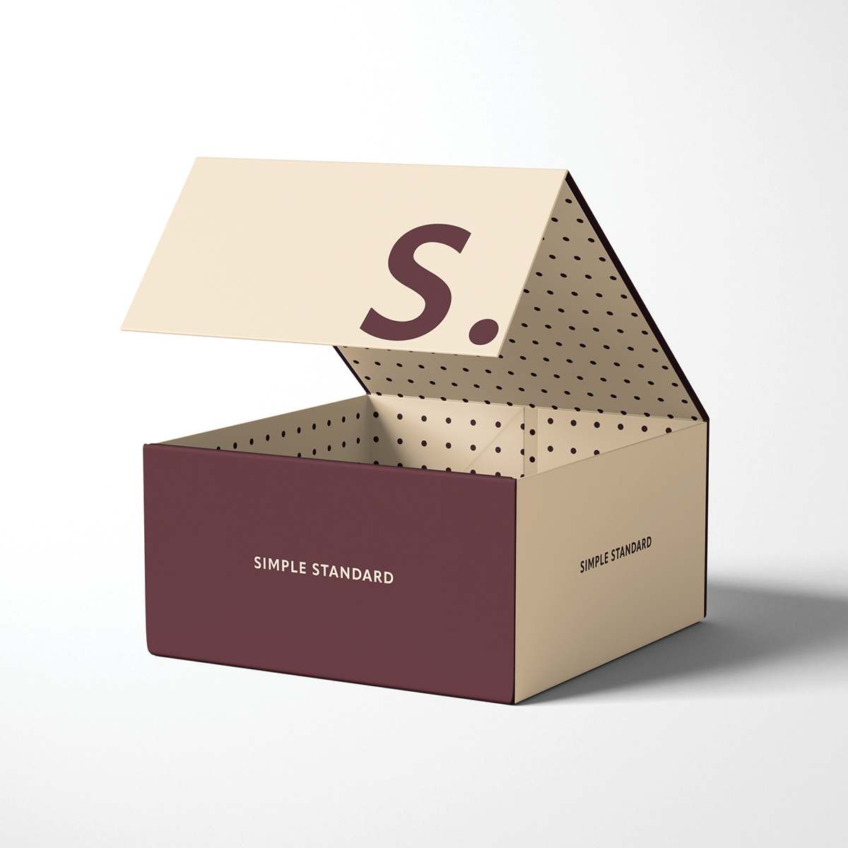 Open burgundy and beige magnetic box featuring printed text and a polka-dot pattern on the interior