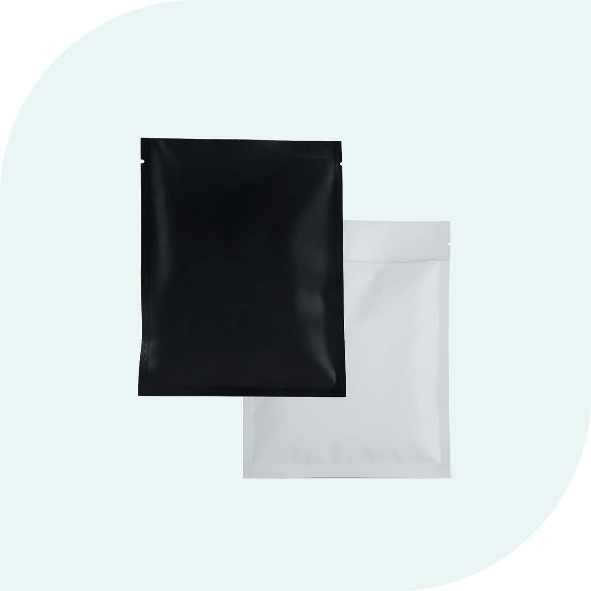 Two plain flat pouches in matte black and white against a light background