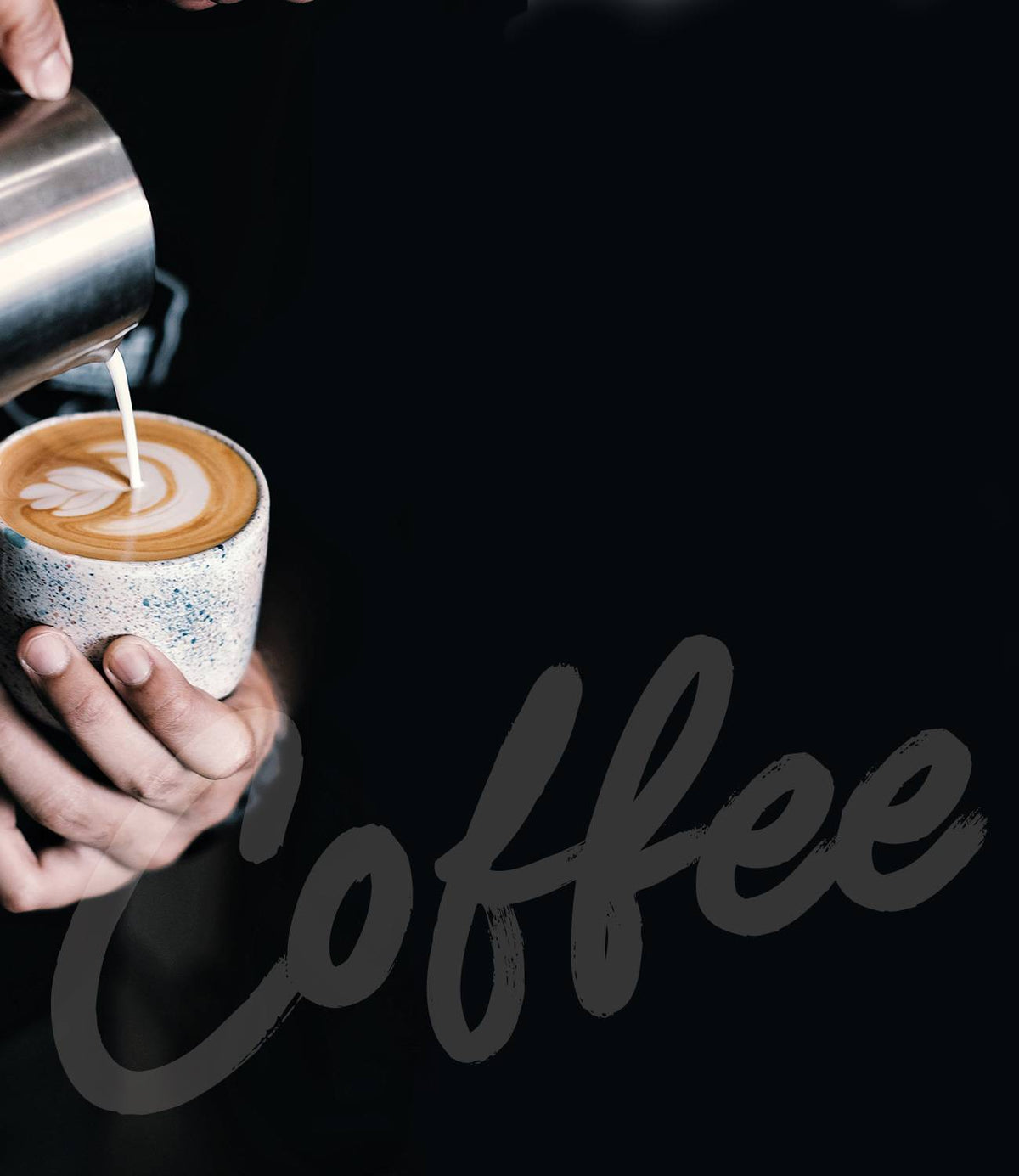 Milk being poured into a speckled cup with latte art against a black background with cursive Coffee text